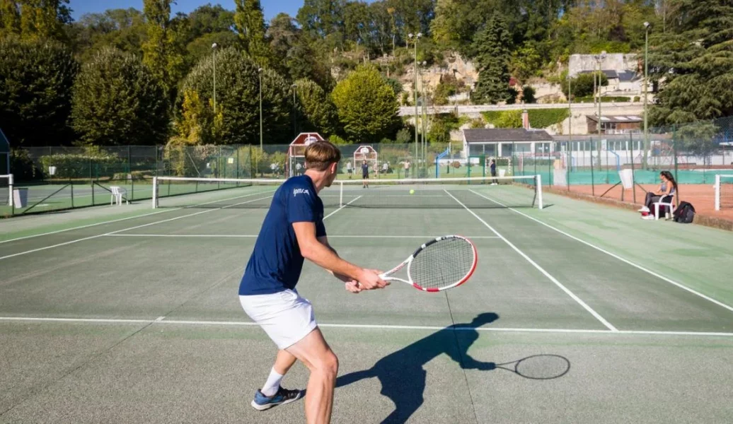 Stagiaire IPMS en pratique tennistique sur court extérieur.