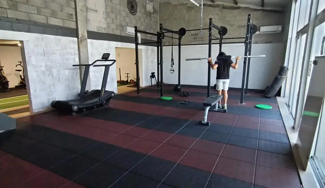 Espace de cross training IPMS Bordeaux : étudiant BPJEPS AF en séance pratique sur rack de musculation.