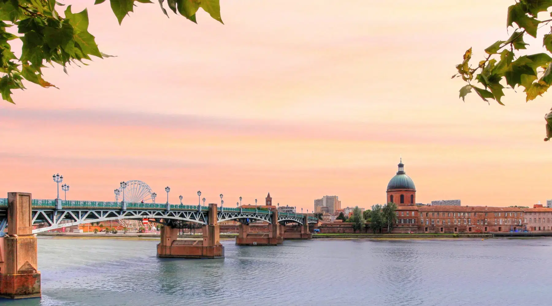 Vue du pont Saint-Pierre et du dôme de La Grave à Toulouse au coucher du soleil.